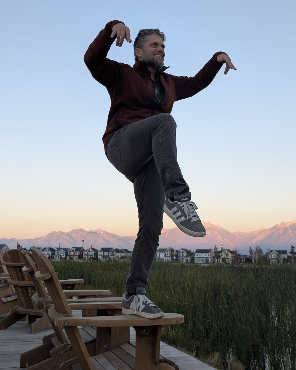 Ben Page on the lake boardwalk in his Utah neighborhood at sunset, Wasatch behind