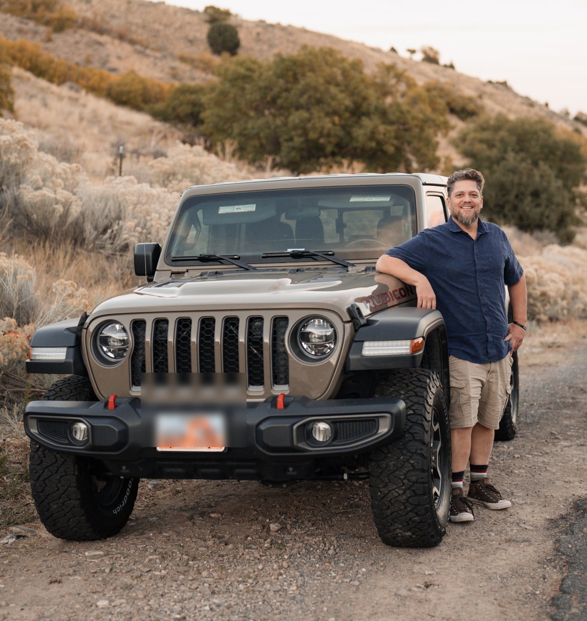 Ben Page with his Jeep in the desert hills