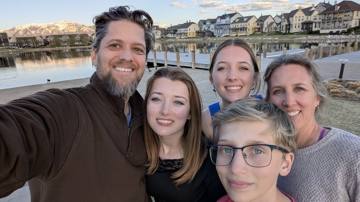 Ben and his family on a lake dock at golden hour