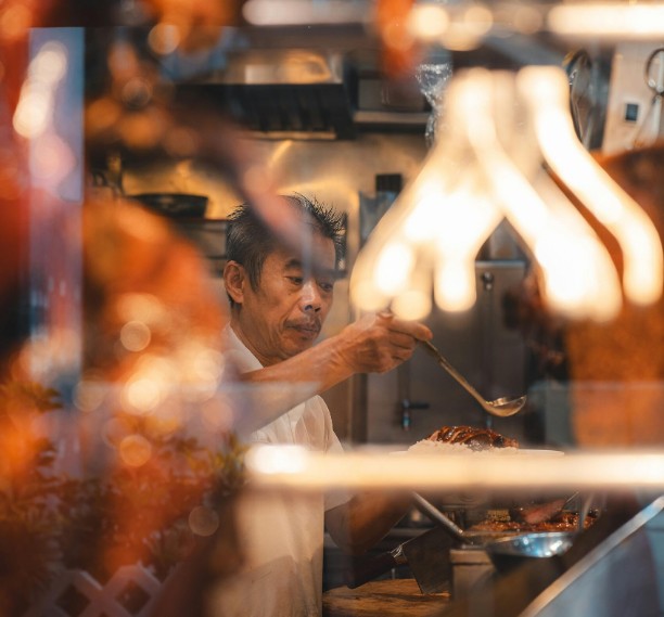 A restaurant owner working the line in his kitchen